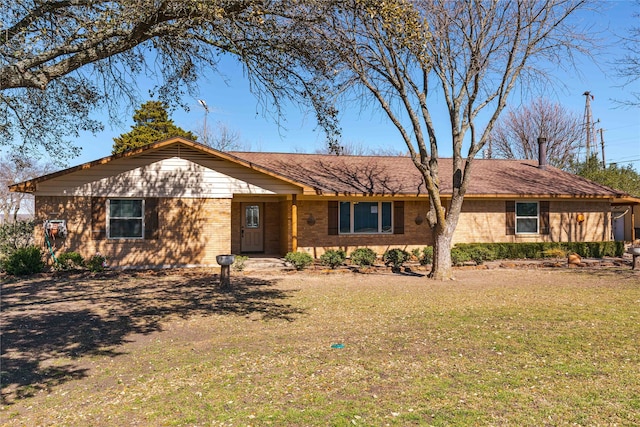 ranch-style house with brick siding and a front lawn