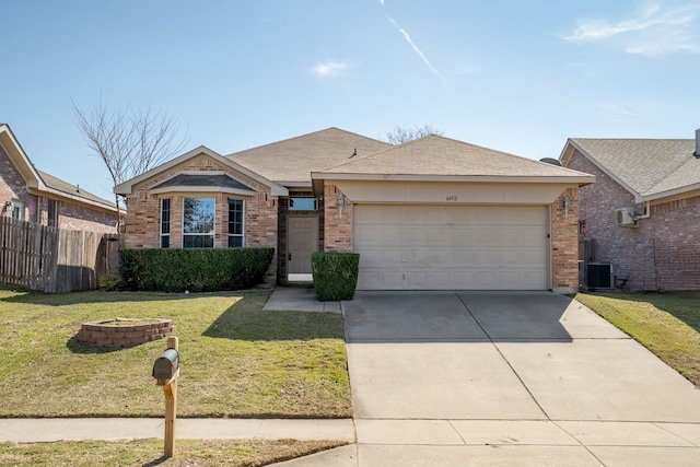 view of front of house featuring a garage, brick siding, fence, driveway, and a front lawn