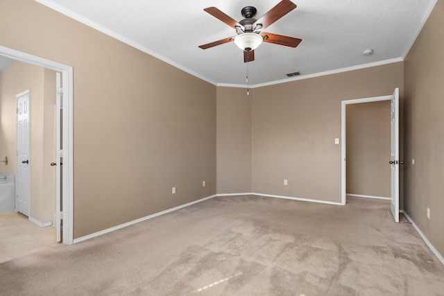 empty room featuring baseboards, ornamental molding, visible vents, and light colored carpet