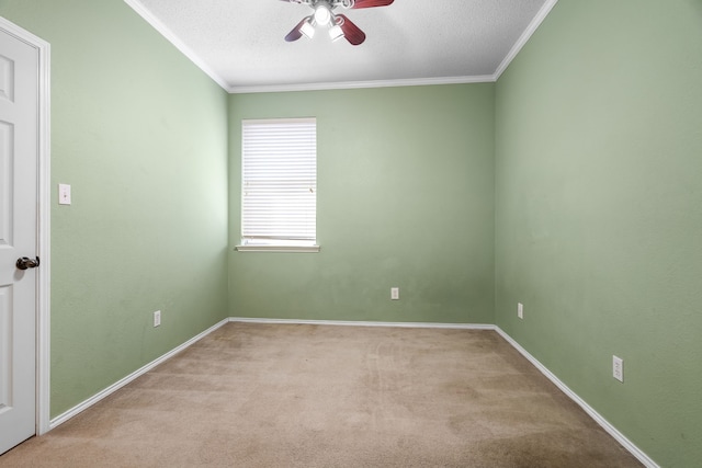 carpeted spare room featuring baseboards, a textured ceiling, a ceiling fan, and crown molding