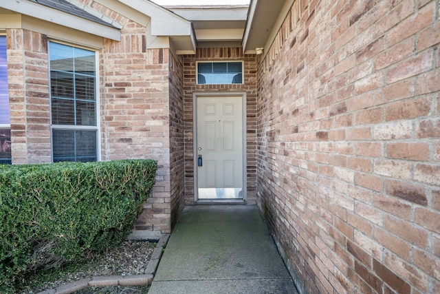 property entrance with brick siding