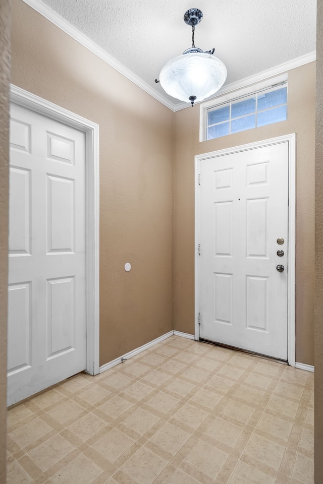 entrance foyer with light floors, crown molding, a textured ceiling, and baseboards