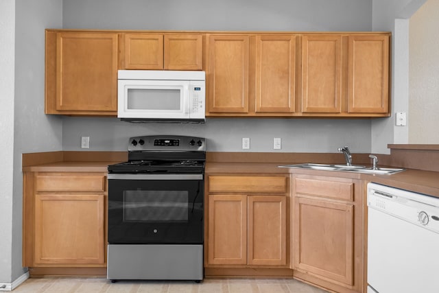 kitchen with white appliances and a sink