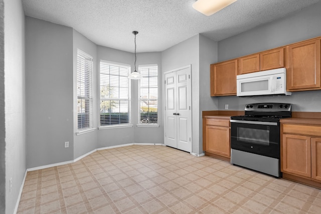 kitchen with white microwave, baseboards, light floors, and electric stove