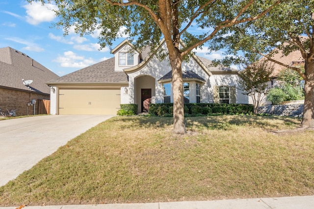 view of front of house with a garage, a shingled roof, concrete driveway, and a front yard