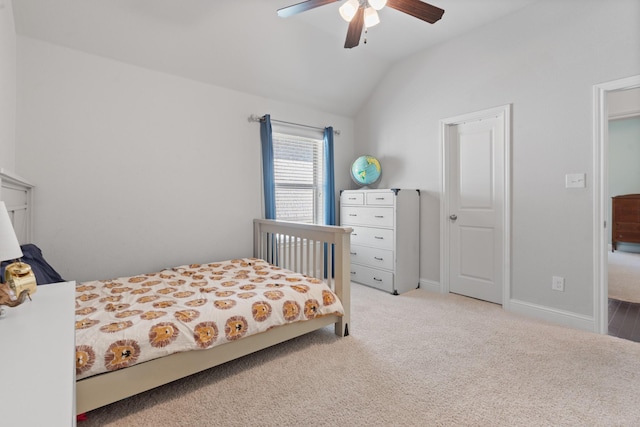 carpeted bedroom featuring a ceiling fan, lofted ceiling, and baseboards