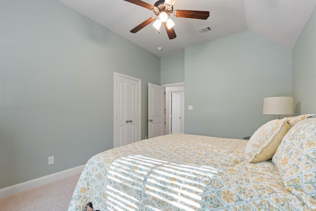 bedroom featuring carpet floors, visible vents, vaulted ceiling, ceiling fan, and baseboards