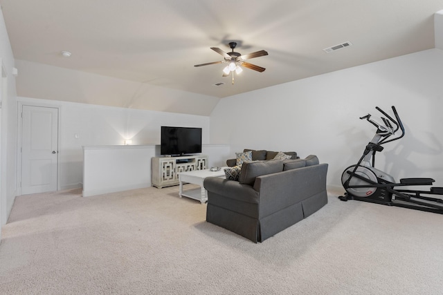 carpeted living area featuring a ceiling fan, visible vents, and vaulted ceiling