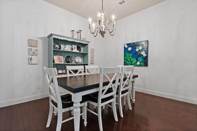 dining space featuring an inviting chandelier, wood-type flooring, visible vents, and baseboards