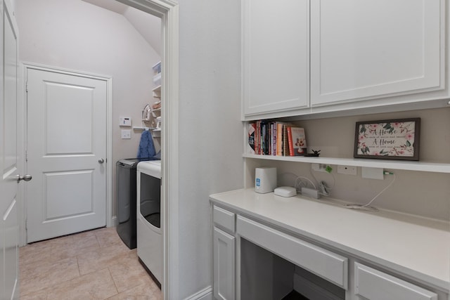 laundry room featuring light tile patterned floors, washer and clothes dryer, and cabinet space