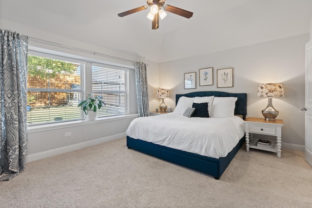 carpeted bedroom featuring lofted ceiling, baseboards, and a ceiling fan