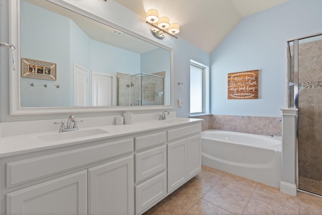 full bath featuring a garden tub, a stall shower, a sink, and tile patterned floors