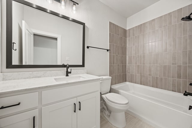 bathroom featuring toilet, washtub / shower combination, and vanity