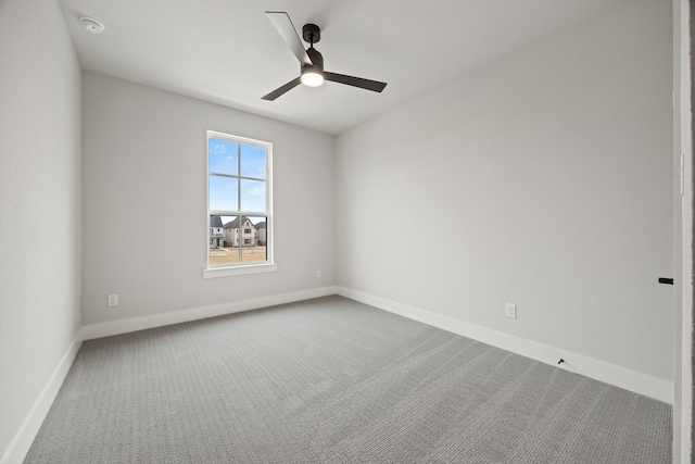 empty room featuring a ceiling fan, baseboards, and carpet flooring