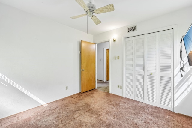 unfurnished bedroom with a ceiling fan, a closet, visible vents, and carpet flooring