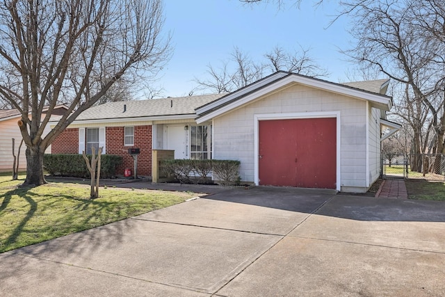 ranch-style home featuring an attached garage, brick siding, fence, concrete driveway, and a front yard