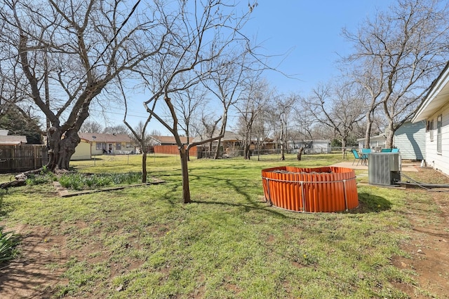 view of yard featuring fence and cooling unit