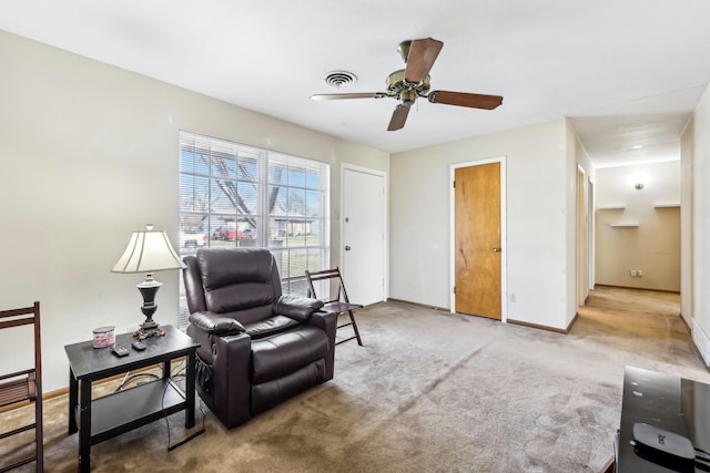 sitting room featuring ceiling fan, carpet floors, visible vents, and baseboards