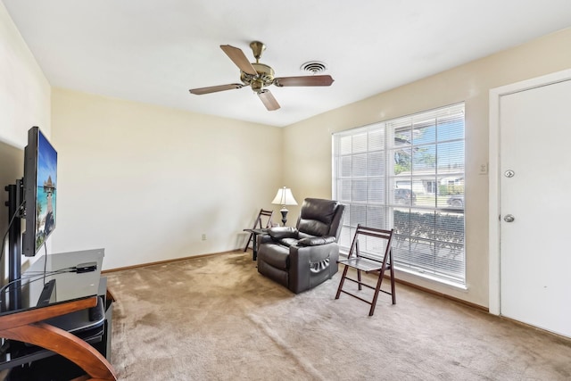 sitting room with carpet floors, visible vents, baseboards, and a ceiling fan