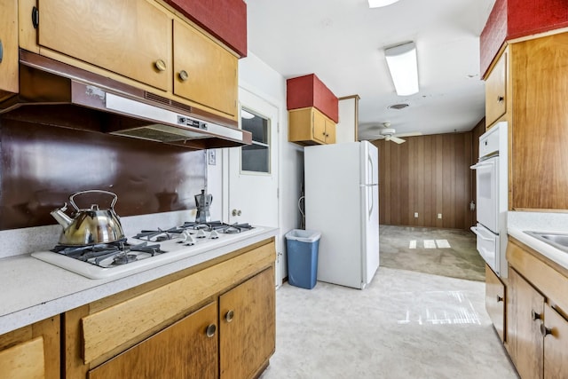 kitchen with visible vents, light countertops, ceiling fan, white appliances, and under cabinet range hood