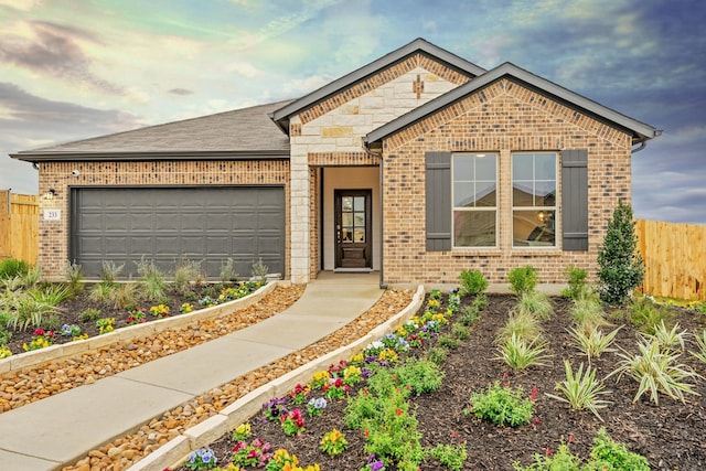 view of front of home with brick siding, stone siding, a garage, and fence