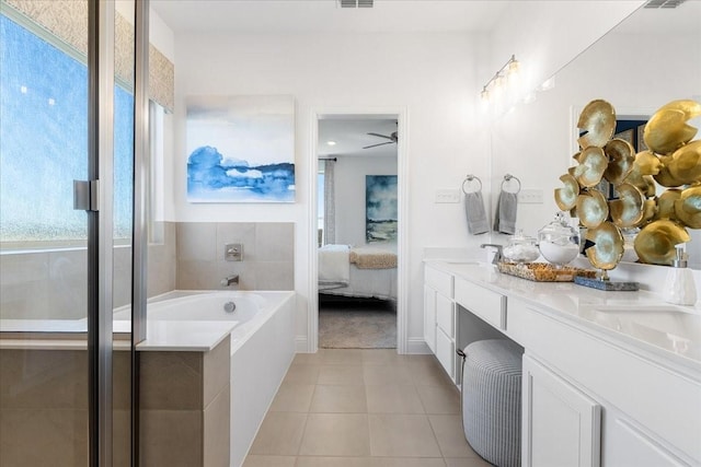 full bath featuring tile patterned floors, a sink, ensuite bath, double vanity, and a bath