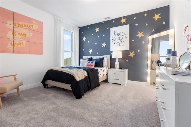 bedroom featuring baseboards, visible vents, carpet floors, wallpapered walls, and an accent wall