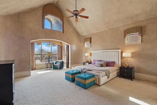 carpeted bedroom featuring high vaulted ceiling, a ceiling fan, and baseboards