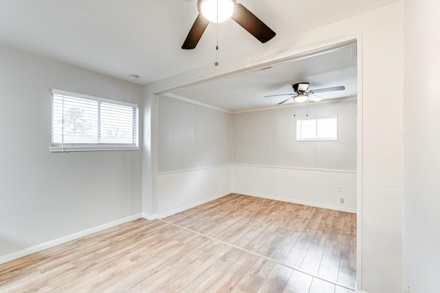 spare room with a ceiling fan, baseboards, and wood finished floors