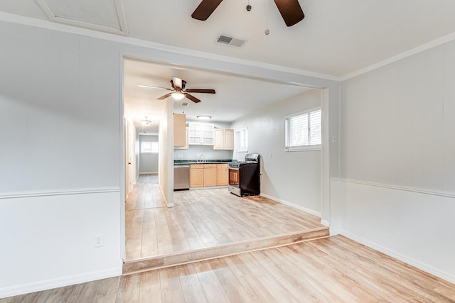 kitchen featuring visible vents, range with gas stovetop, dark countertops, light wood-style flooring, and stainless steel dishwasher