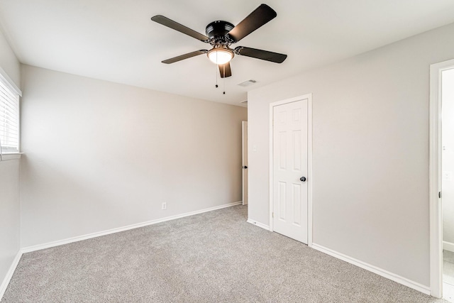 unfurnished bedroom featuring baseboards, visible vents, ceiling fan, and carpet flooring