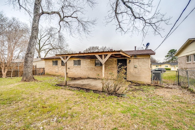 back of property featuring a patio area, brick siding, a lawn, and fence