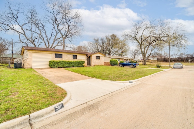 view of front of property featuring cooling unit, brick siding, driveway, and a front lawn