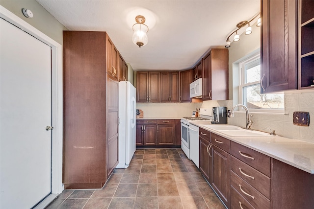 kitchen with open shelves, tasteful backsplash, light countertops, a sink, and white appliances