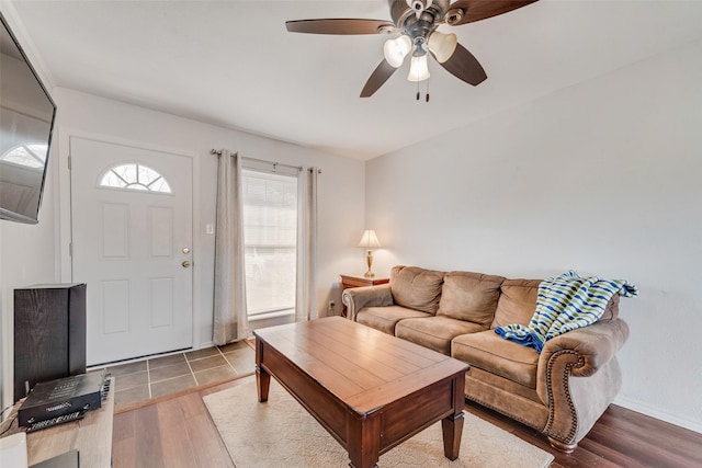 living area with wood finished floors and a ceiling fan