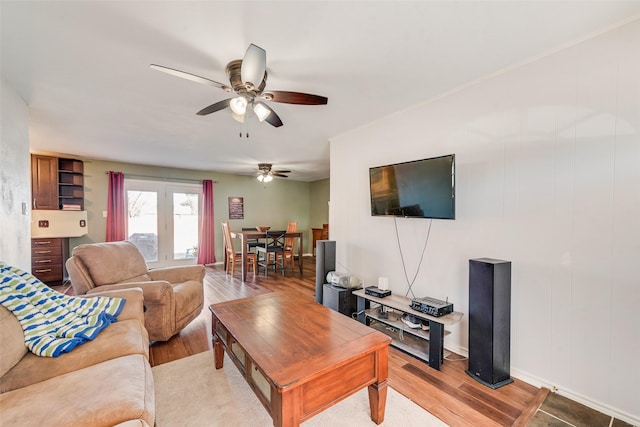 living room with light wood finished floors and ceiling fan