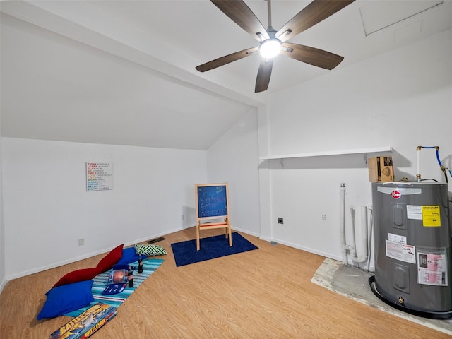 game room with electric water heater, wood finished floors, a ceiling fan, baseboards, and vaulted ceiling