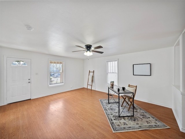 office with a ceiling fan, baseboards, and wood finished floors