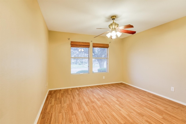 unfurnished room with light wood finished floors, ceiling fan, and baseboards