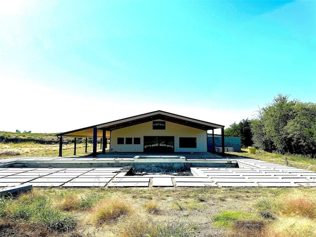 back of property with a patio