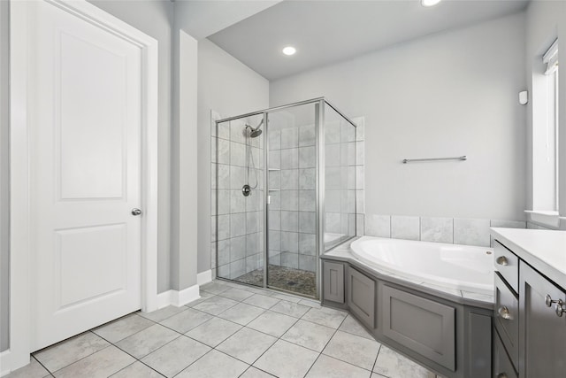 full bath featuring a garden tub, a shower stall, and tile patterned flooring