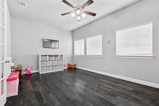 rec room with ceiling fan, wood finished floors, visible vents, and baseboards