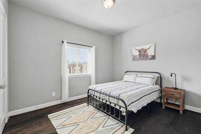 bedroom featuring wood finished floors and baseboards