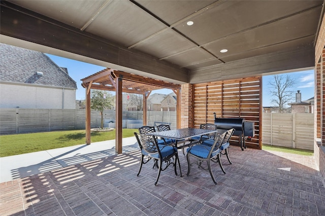 view of patio featuring outdoor dining area, a fenced backyard, and grilling area