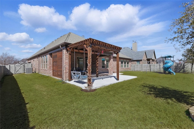 rear view of property featuring brick siding, a patio area, a playground, and a fenced backyard