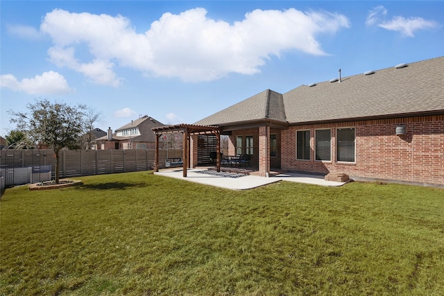 rear view of house featuring a pergola, a patio area, brick siding, and a fenced backyard