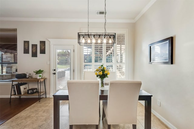 dining space with visible vents, crown molding, and baseboards