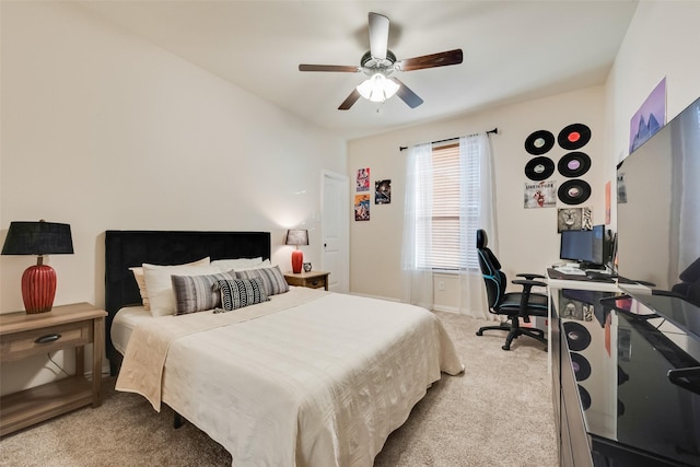 carpeted bedroom with ceiling fan and baseboards