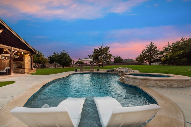 view of pool featuring an outdoor stone fireplace, a lawn, and fence