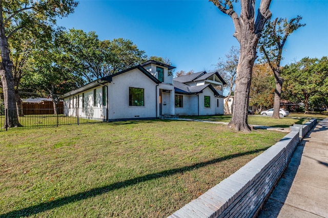 modern farmhouse featuring fence and a front lawn